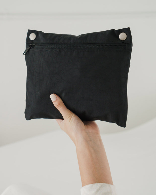 A BAGGU Cloud Bag in Black packed into its pocket pouch