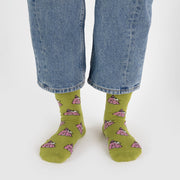 A person wearing a pair of BAGGU Crew Socks in Snoopy