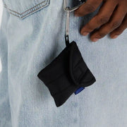 A BAGGU puffy earbud or headphone case in Black on a keychain