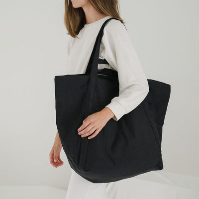 Person holding Baggu Travel Cloud Bag in Black