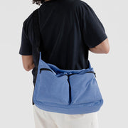 A Baggu Large Cargo Crossbody bag in Pansy Blue worn crossbody