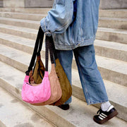 A person holding a small, medium and large crescent for comparison