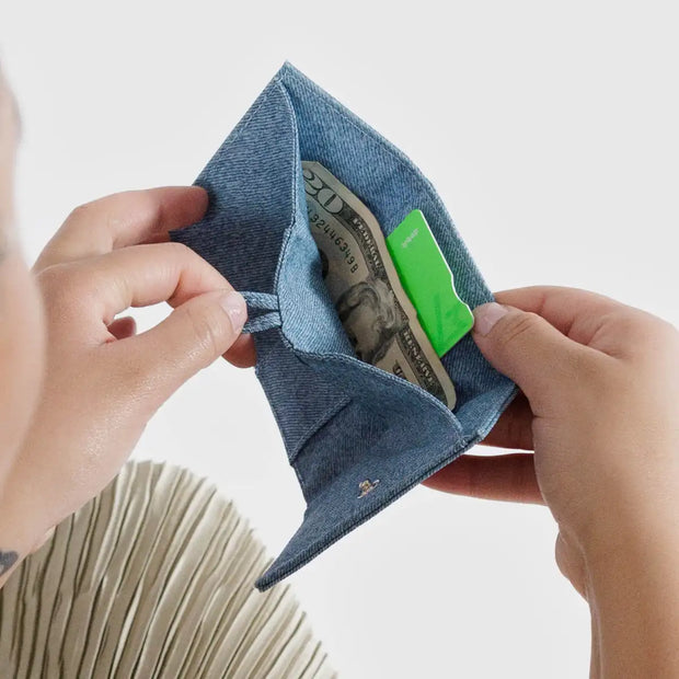 A person holding a A Baggu Snap Wallet in Digital Denim