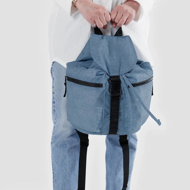 A person holding a Baggu Sports Backpack in Digital Denim