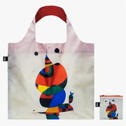 A recycled reusable bag from LOQI featuring the Woman, Bird and Star artwork from Joan Miro photographed with its pouch.